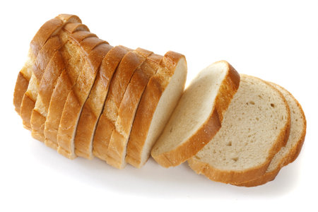 a loaf of fresh bread, cut into thin slices, on a white background, isolated