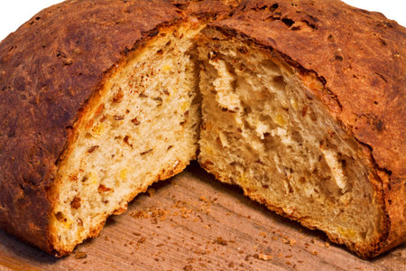 loaf of fresh bread with a crispy crust on a wooden board