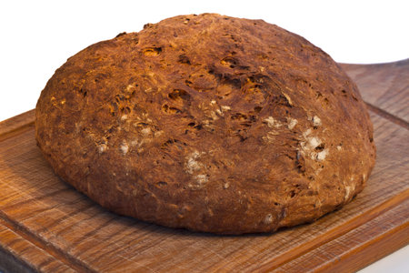 loaf of fresh bread with a crispy crust on a wooden board