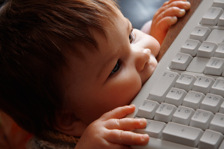 little baby with on a computerの写真素材