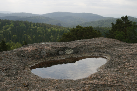 Puddle after the rain in the granite rock.の写真素材