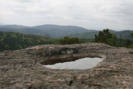 Puddle after the rain in the granite rock.の写真素材