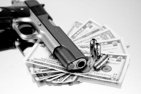 Black & White, 45 Magnum resting on US bills with bulletsの写真素材
