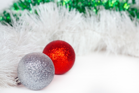 Silvery and red balls with white and green Christmas tinselの写真素材