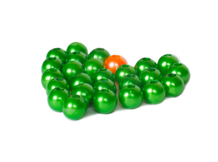 Heart shape of green and orange beadsの写真素材