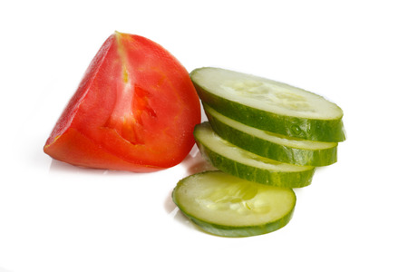 Slised tomatoes and cucumber on a white backgroundの写真素材