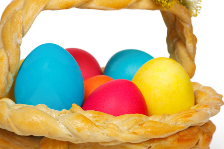 Baked basket with Easter colored eggs の写真素材