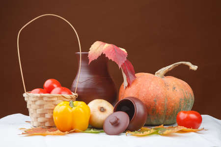 Autumn still life with the vegetables, jug and busketの写真素材