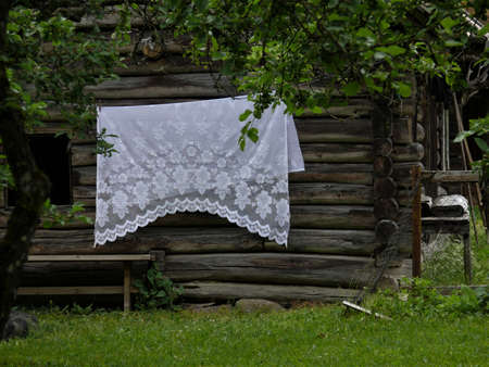 Lace ceiling hangs to dry on a house wallの写真素材