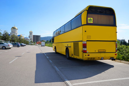 Empty touristic bus is standing on the road near the mountain