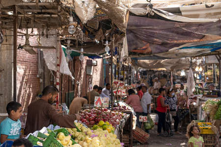 Hurghada, Egypt, November 03, 2021: Stalls with a large selection of fruits, greenery and vegetables. The trading day is in full swing. Both locals and tourists crowd around the stalls and choose the freshest foodのeditorial素材