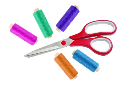 Red metal scissor and colorful sewing threads isolated on whiteの写真素材