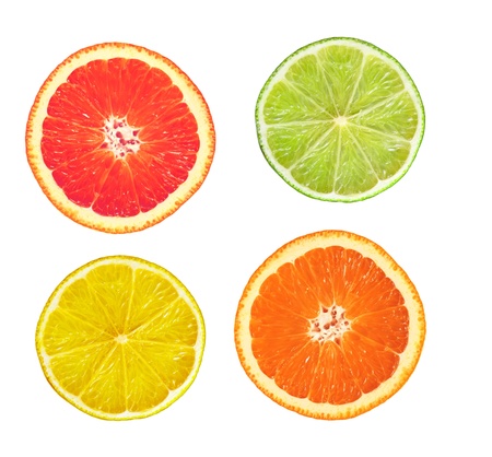 sliced pink grapefruit, lime, lemon and orange isolated on whiteの写真素材