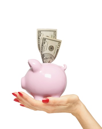 piggy bank with money on woman hand isolated over whiteの写真素材