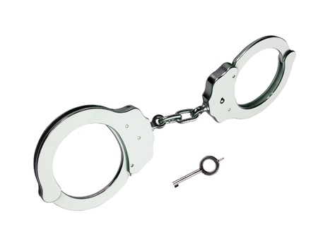 metal handcuffs with key isolated on white backgroundの写真素材
