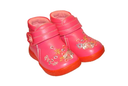Shoes for little girls decorated with flowers isolated on white backgroundの写真素材