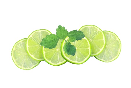 Fresh juicy lime slices and mint leaves isolated on whiteの写真素材
