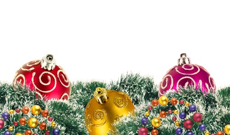 Colorful christmas balls among green new year tree over whiteの写真素材