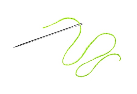 Green thread and needle isolated on whiteの写真素材