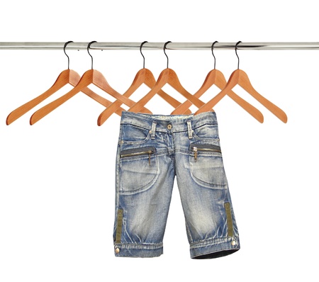 jeans on hangers isolated on whiteの写真素材