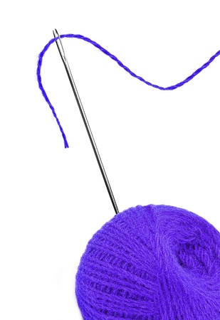 Blue thread ball and needle with pink thread isolated on whiteの写真素材
