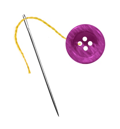 Yellow thread, needle and button isolated on white backgroundの写真素材