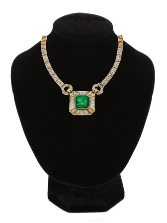 beautiful gold jewellery necklace with green stone on black mannequin isolated on white の写真素材