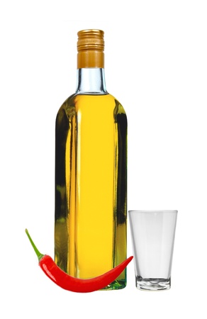 bottle of vodka with red pepper and glass isolated on white backgroundの写真素材