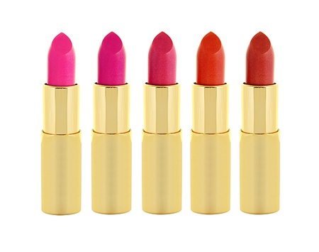 beautiful red and pink lipsticks in golden tube isolated on whiteの写真素材