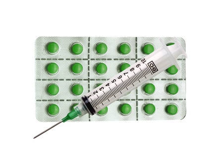 Tablets  pills  and syringe isolated on whiteの写真素材