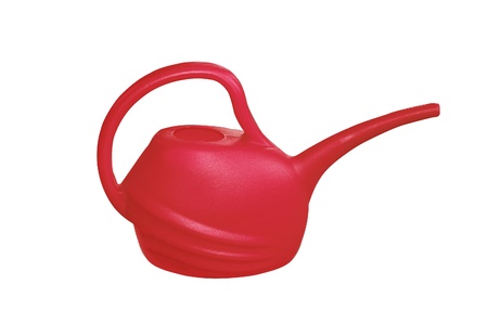 red plastik watering can isolated on white backgroundの写真素材