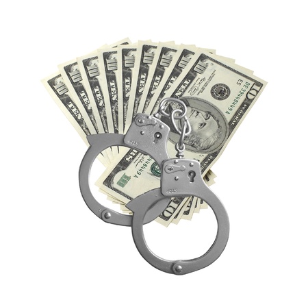 many dollars and handcuffs isolated on white backgroundの写真素材
