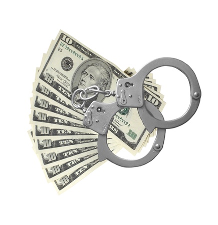 many dollars and handcuffs isolated on white backgroundの写真素材