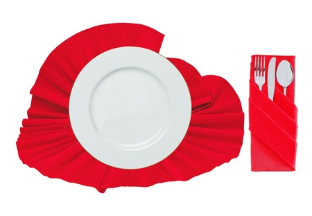 Fork, spoon, knife and white plate on red cloth isolated on whiteの写真素材