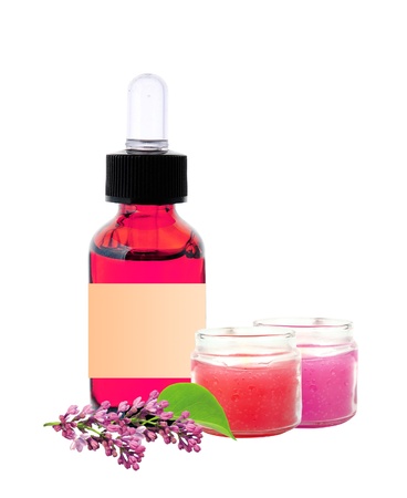 bottle with essence oil and lilac flowers isolated on whiteの写真素材