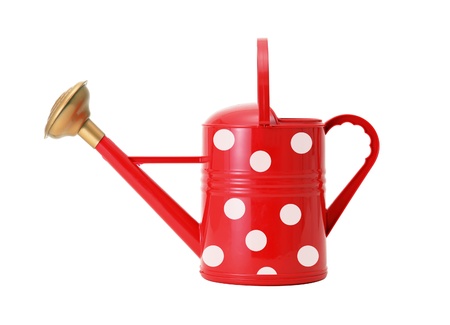 red polka dot watering can isolated on whiteの写真素材