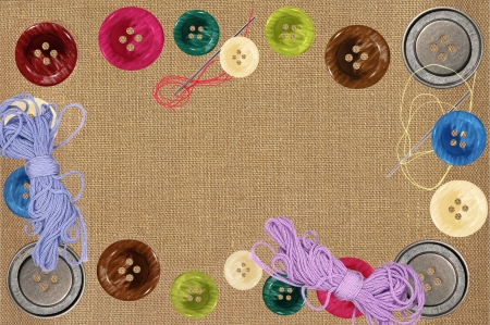 Bright sewing buttons and needles on gray fabricの写真素材