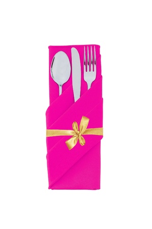 Fork, spoon and knife in pink cloth with golden bow isolated on white backgroundの写真素材