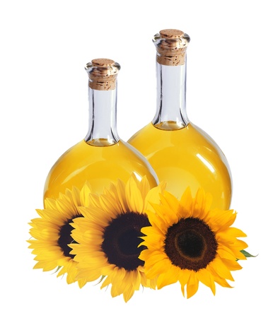 oil in bottles and sunflowers, isolated on white backgroundの写真素材