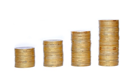 Many coins in column isolated on whiteの写真素材