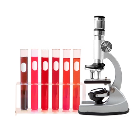 Medical test tubes with blood in holder and microscope on white backgroundの写真素材
