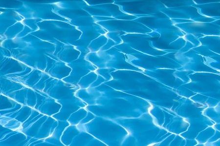 beautiful clear pool water reflecting in the sun backgroundの写真素材