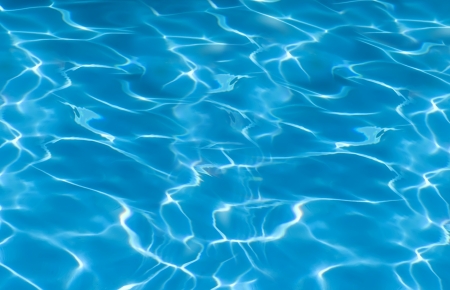 beautiful clear pool water reflecting in the sun backgroundの写真素材