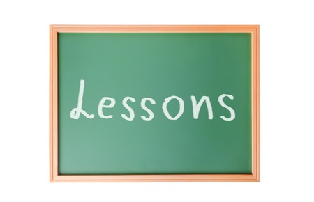 Writing on school blackboard isolated on white backgroundの写真素材