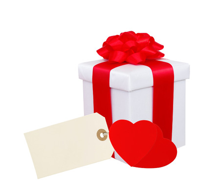 Gift box with red ribbon, hearts and tag (label) isolated on white backgroundの写真素材