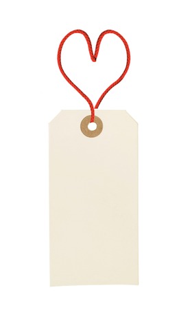 cardboard tag with red heart ribbon isolated on white backgroundの写真素材