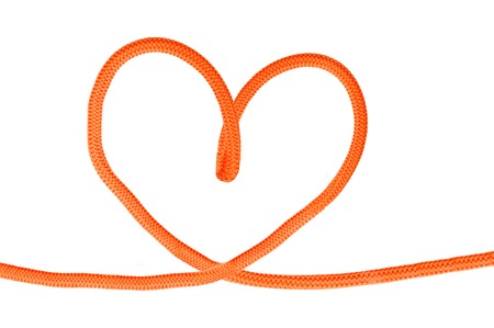 Heart shaped red knot on a jute rope isolated on white backgroundの写真素材