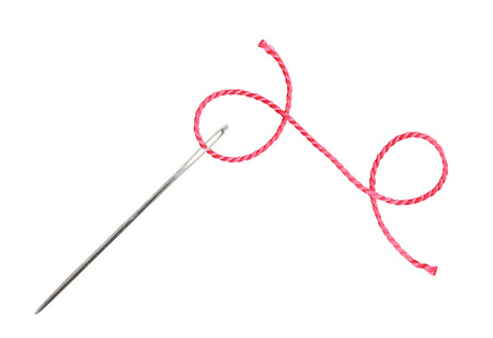 Red thread and needle isolated on white backgroundの写真素材