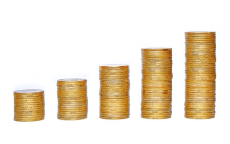 Many coins in column isolated on whiteの写真素材