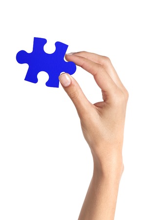 Blue puzzle in woman hand isolated on white backgroundの写真素材